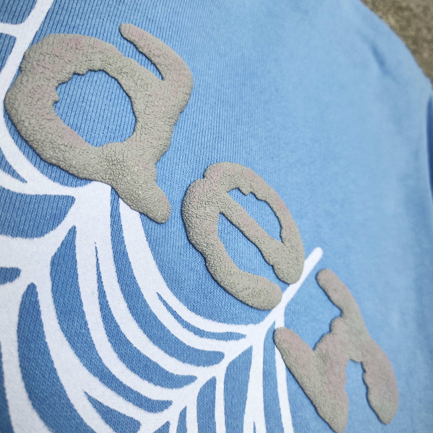 Full front artwork on Sp5der OG Web V2 Hoodie Dusty Blue with grey puff logo and white web
Close-up of raised grey SP5DER puff-print lettering on the Dusty Blue OG Web V2 Hoodie
Side angle showing the three-dimensional grey puff-print texture on Sp5der Dusty Blue Hoodie
Close-up of the white Web V2 spider-web graphic on Sp5der OG Hoodie Dusty Blue