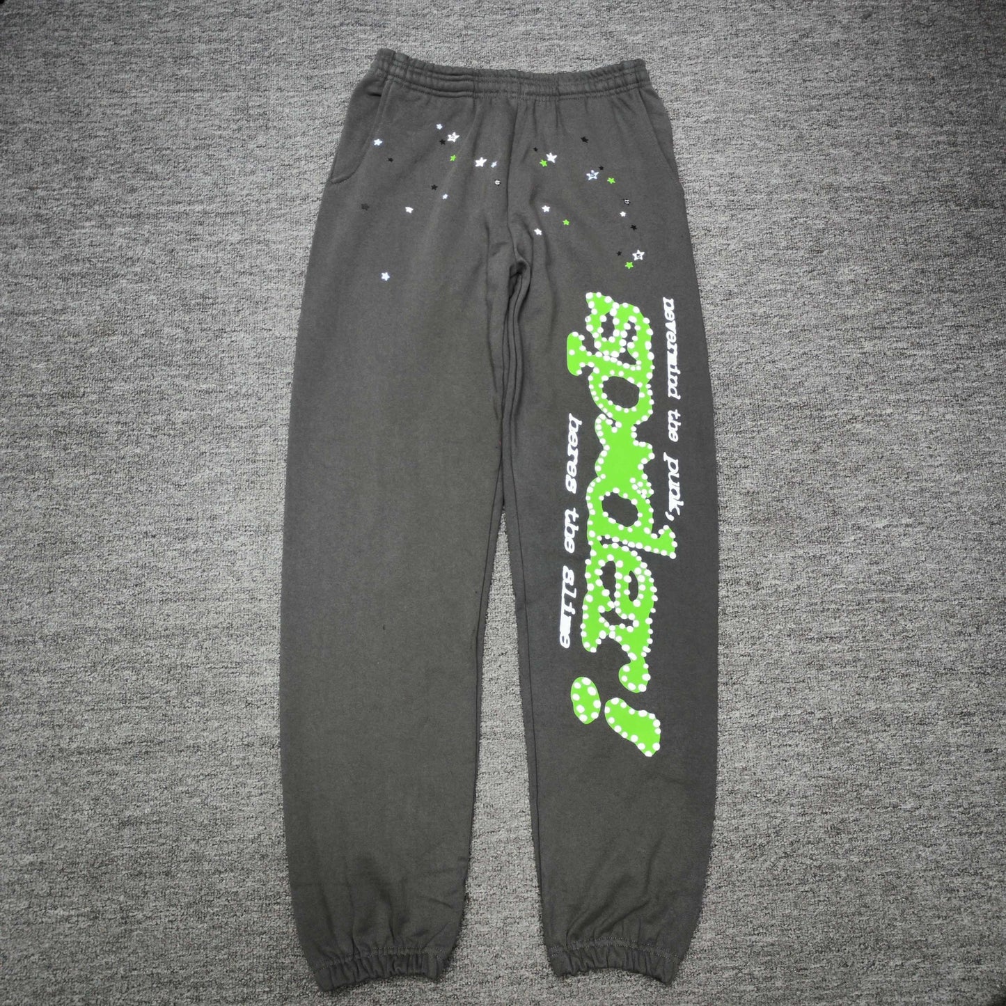 SP5DER Punk V2 slate grey sweatpants front view with green leg graphic and scattered stars