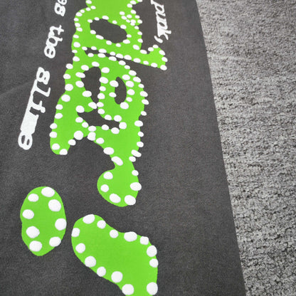 White dot detailing around the green SP5DER graphic on Punk V2 sweatpants