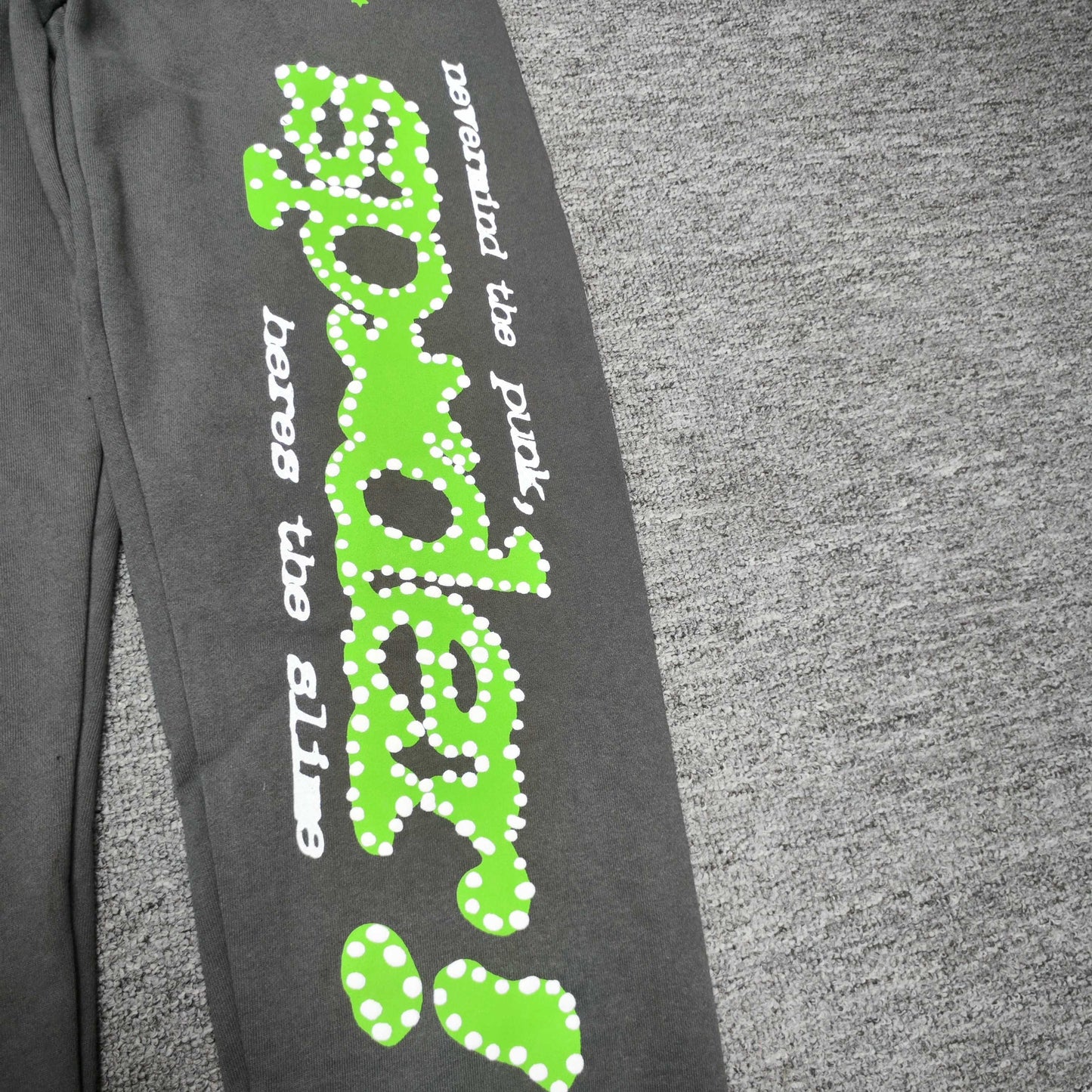 Green P*NK SP5DER leg graphic and scattered stars on slate grey Punk V2 sweatpants