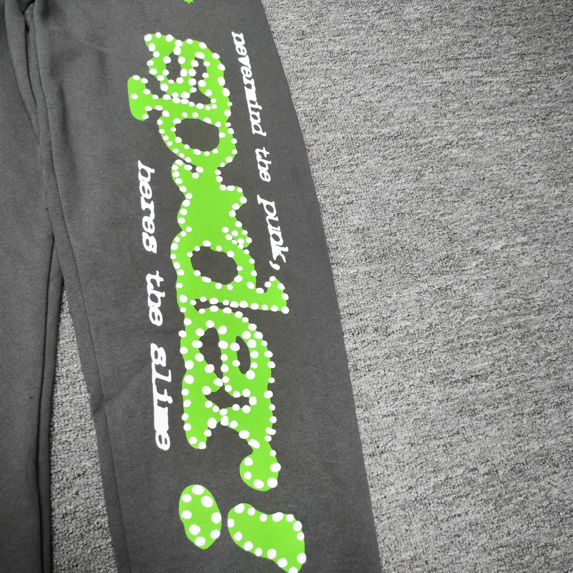 Green P*NK SP5DER leg graphic and scattered stars on slate grey Punk V2 sweatpants