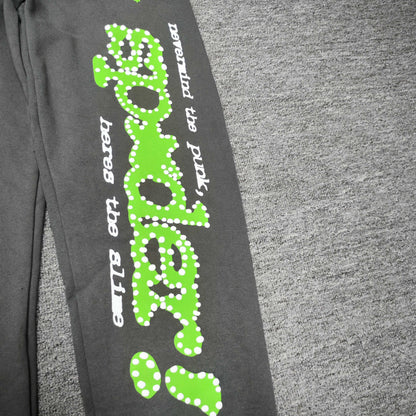 Green P*NK SP5DER leg graphic and scattered stars on slate grey Punk V2 sweatpants