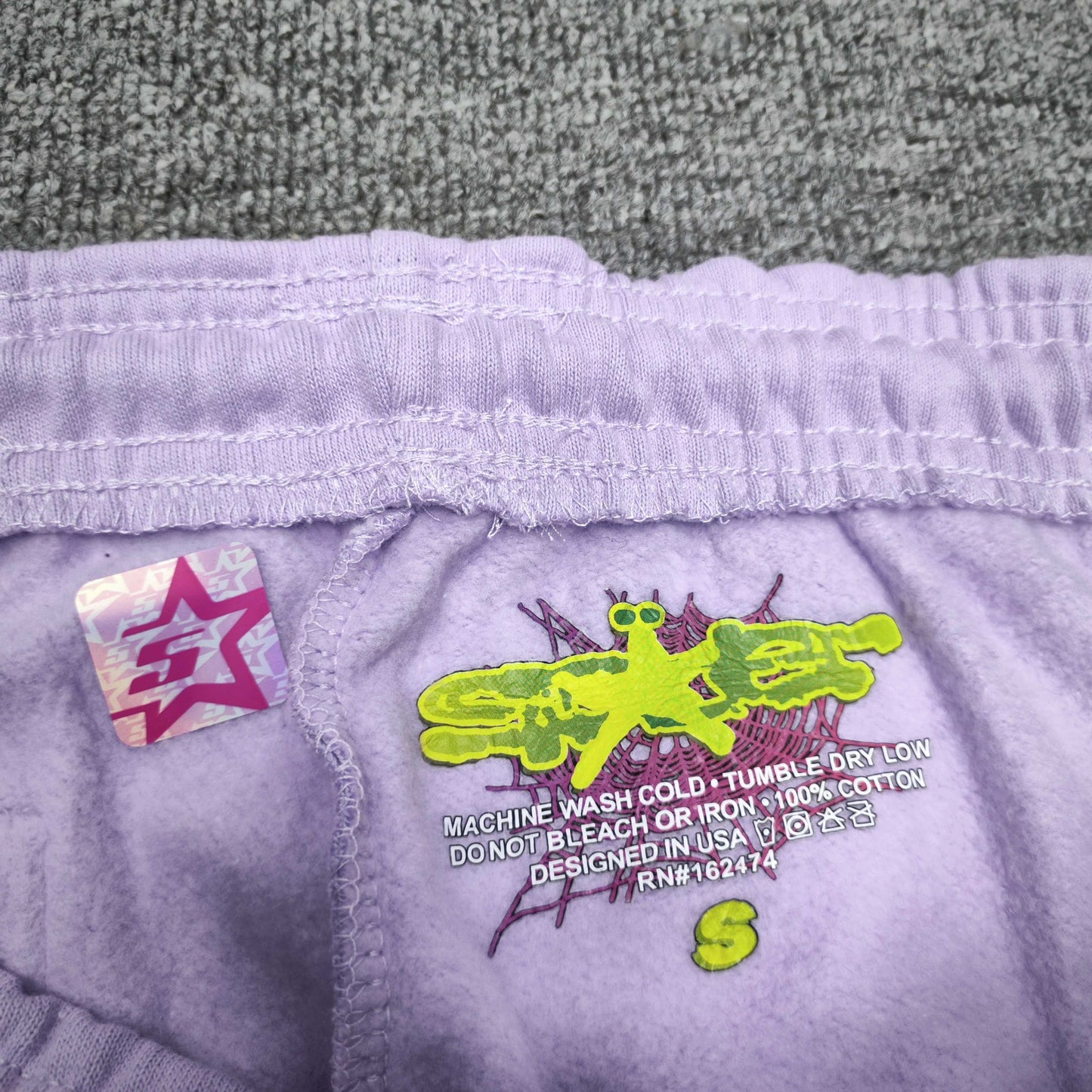SP5DER Acai purple sweatpants size label detail