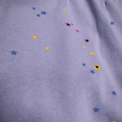 Scattered multicolor star graphics on SP5DER Acai purple sweatpants