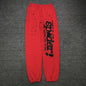 SP5DER P*NK V2 red sweatpants front view with black leg graphic and scattered stars