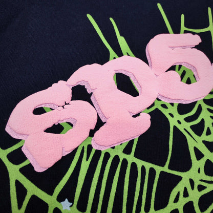 Full front artwork on Sp5der OG Web Hoodie Navy with pink puff logo, green web and stars
Close-up of raised pink SP5DER puff-print lettering on the Navy OG Web Hoodie
Side angle showing the three-dimensional pink puff-print texture on Sp5der OG Web Hoodie Navy
Close-up of mint-green spider-web artwork on Sp5der OG Web Hoodie Navy