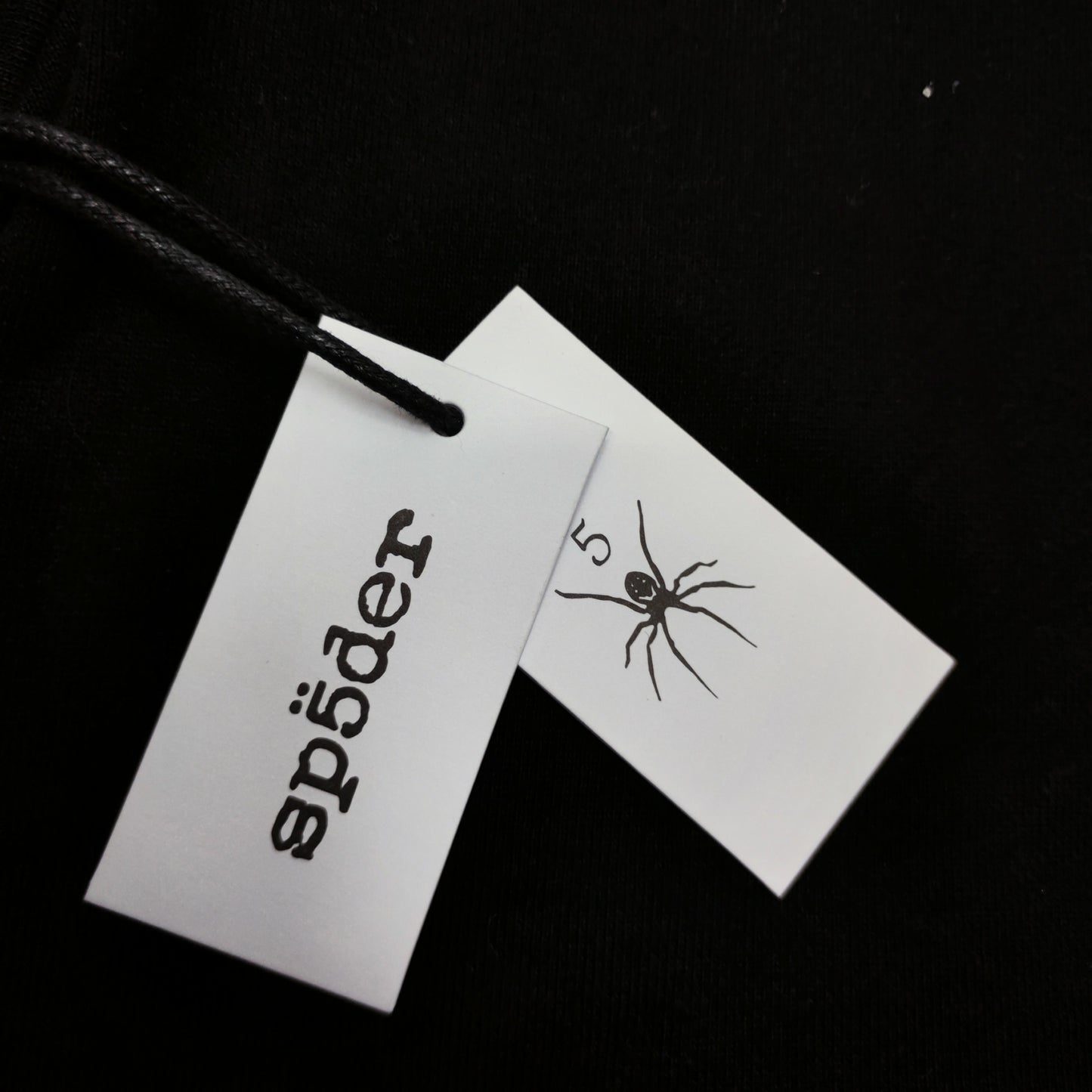 Sp5der OG Web V2 Hoodie Black neck label and size tag detail
Sp5der OG Web V2 Hoodie Black care label and washing instruction detail