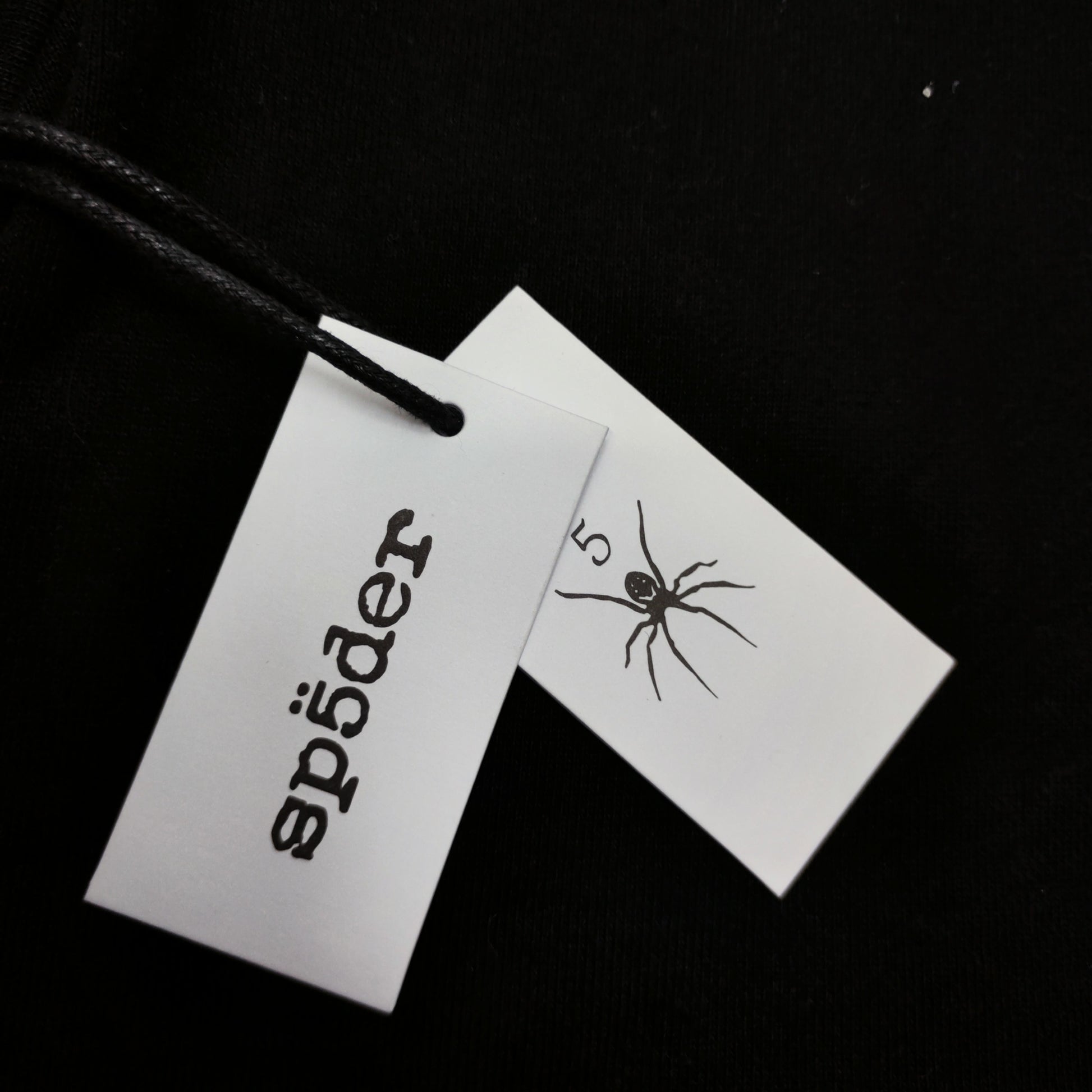 Sp5der OG Web V2 Hoodie Black neck label and size tag detail
Sp5der OG Web V2 Hoodie Black care label and washing instruction detail