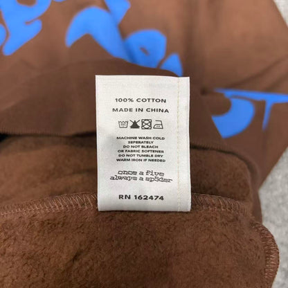 Sp5der Beluga Hoodie Brown neck label and size tag detail
Sp5der Beluga Hoodie Brown care label and washing instruction detail