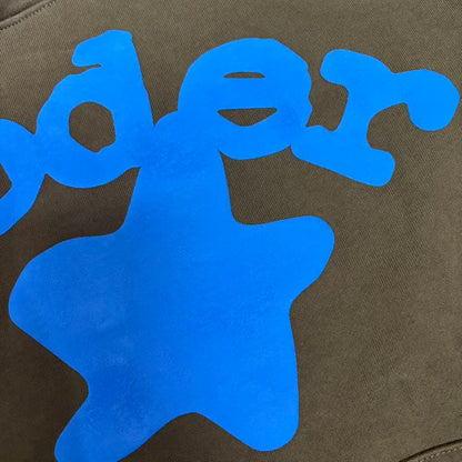 Full blue puff-print artwork on Sp5der Beluga Hoodie Brown with logo, stars and number graphics
Close-up of raised blue SP5DER lettering and clean puff-print edges on the brown Beluga Hoodie
Side angle showing the three-dimensional blue puff-print texture on Sp5der Beluga Hoodie Brown
Oversized blue star graphics across the front of Sp5der Beluga Hoodie Brown
