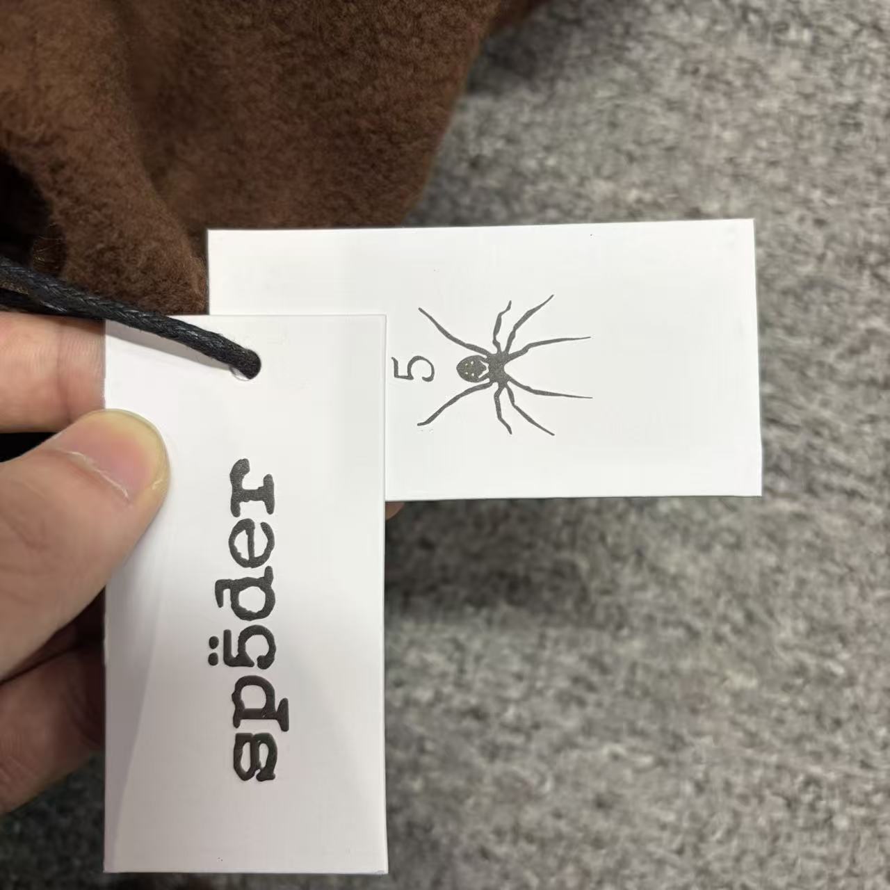 SP5DER Beluga V2 brown sweatpants size label detail