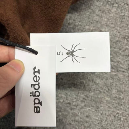 SP5DER Beluga V2 brown sweatpants size label detail