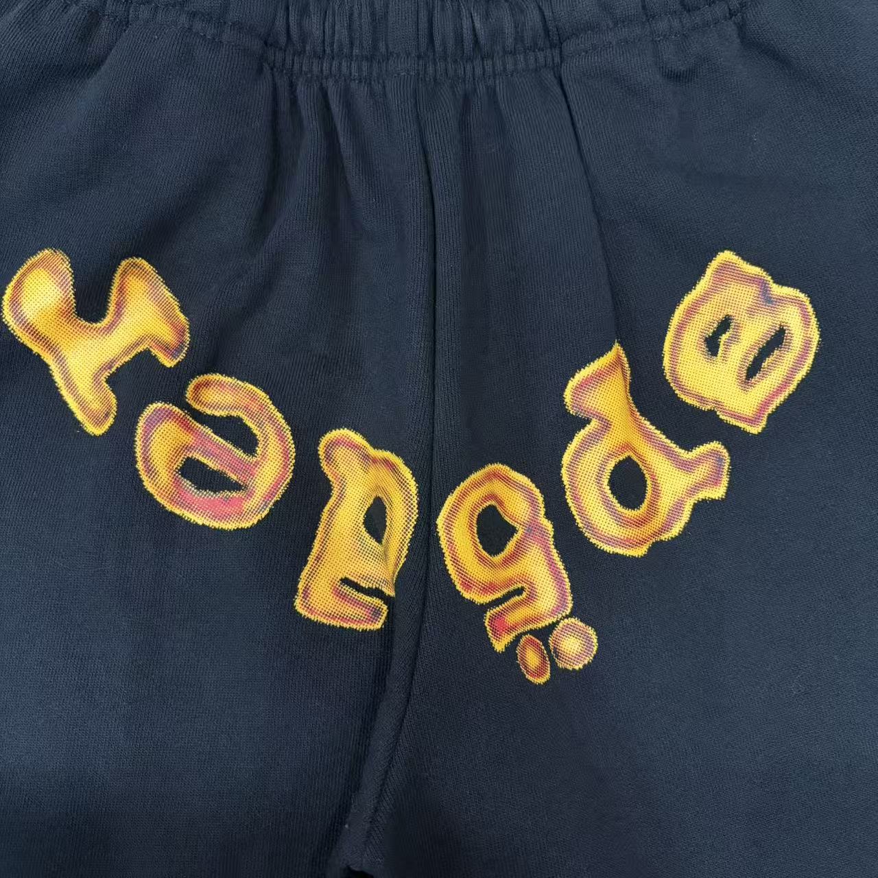 Close-up of orange chenille-style SP5DER lettering on Issue 404 sweatpants
Frayed edge detail on orange SP5DER chenille lettering
Close-up of stitched edges on SP5DER Issue 404 chenille logo
Faded graphic print detail on SP5DER Issue 404 black sweatpants