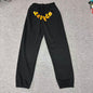 SP5DER Issue 404 black sweatpants front view with raised orange chenille logo