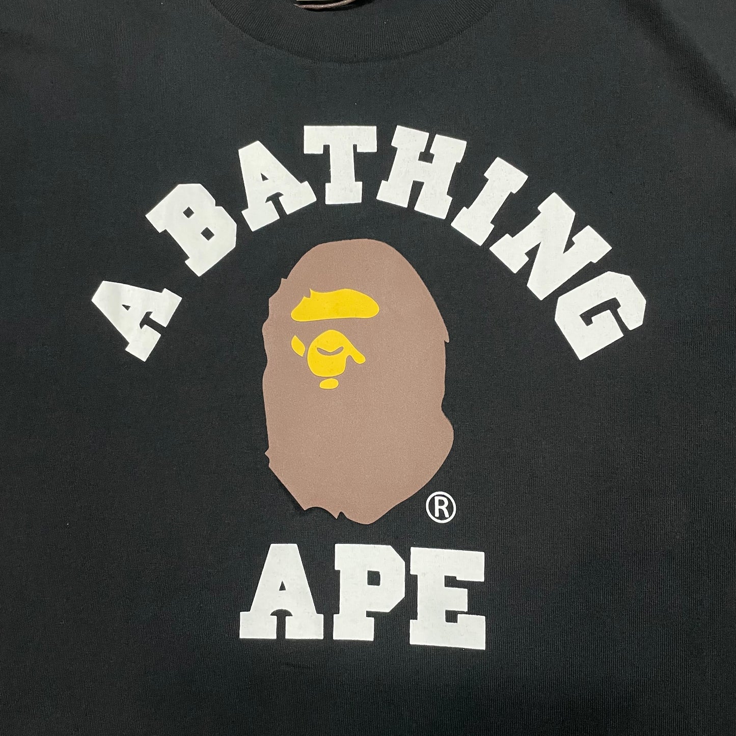 BAPE College lettering and Ape Head graphic detail on black T-shirt