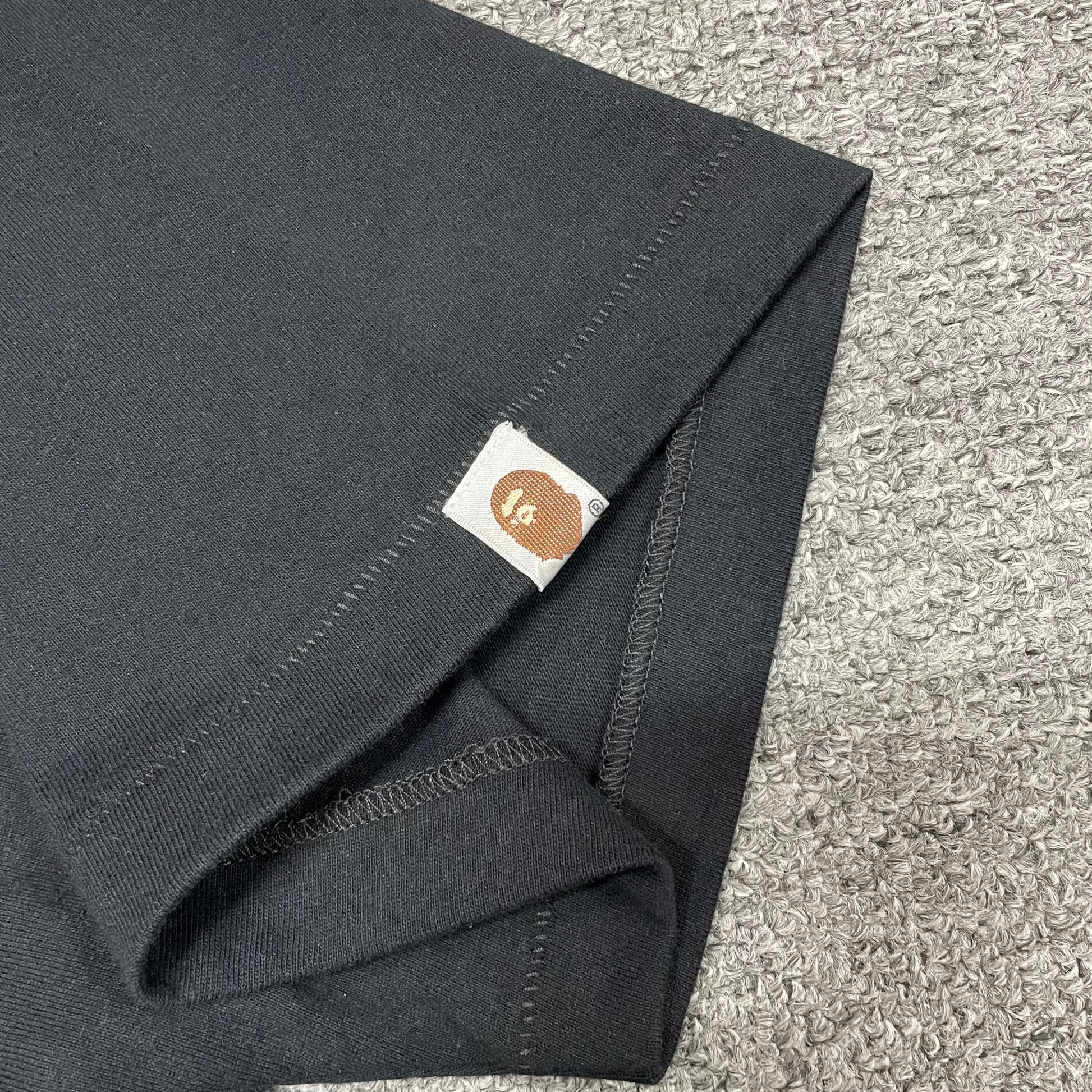 BAPE Check graphic T-shirt sleeve label and stitching detail