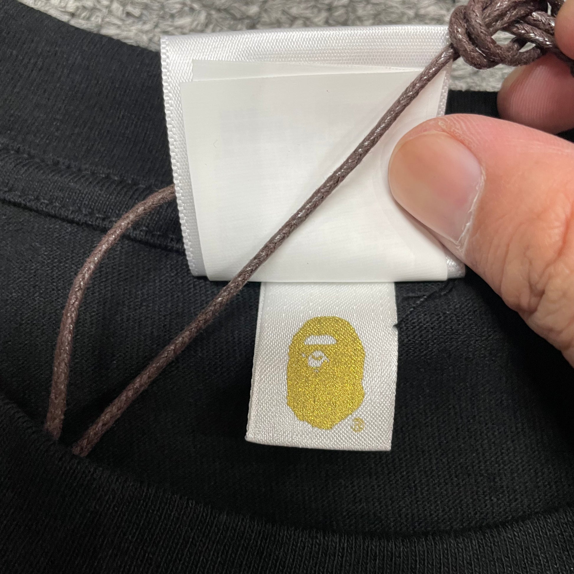 Gold label detail on black BAPE ABC Camo Big Ape Head T-shirt