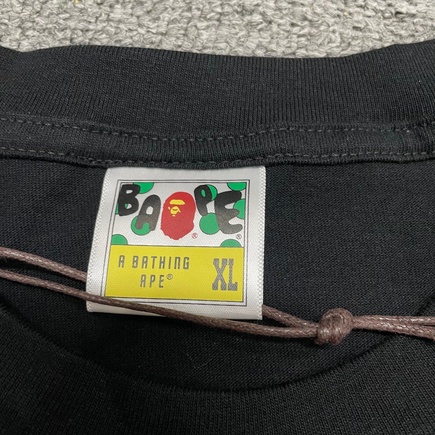 Neck label detail of black BAPE Big Ape Head T-shirt