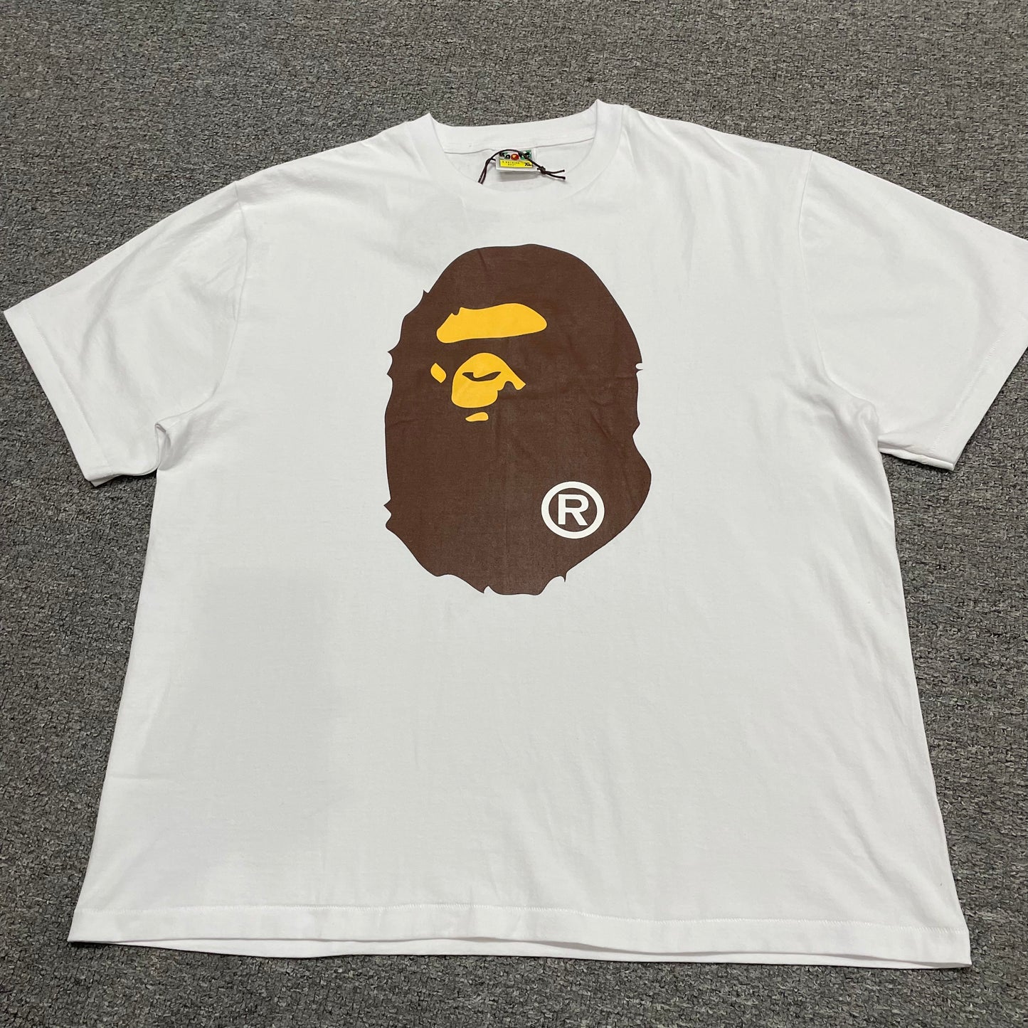 White BAPE Big Ape Head T-shirt front view with brown and yellow graphic
