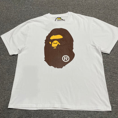 White BAPE Big Ape Head T-shirt front view with brown and yellow graphic