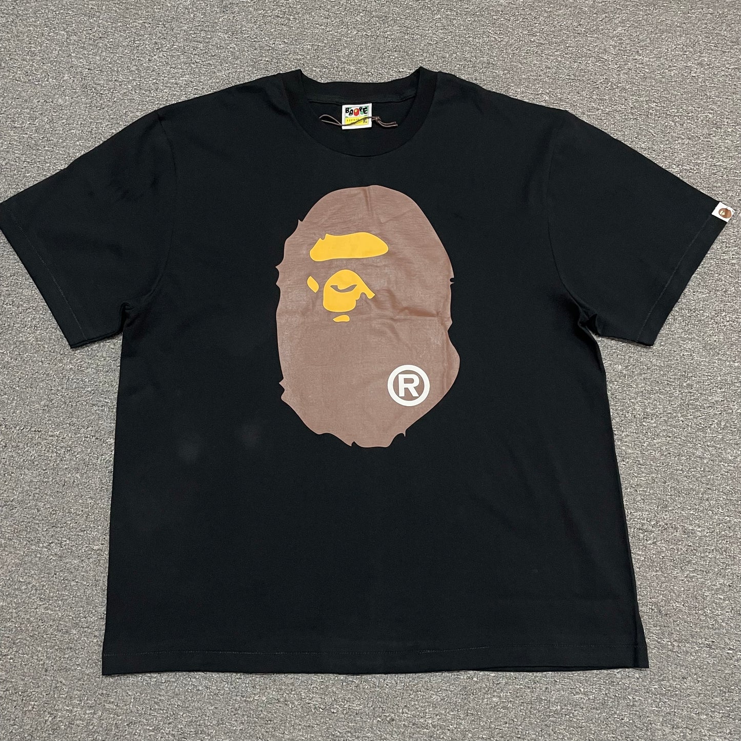 Black BAPE Big Ape Head T-shirt front view with brown and yellow graphic
