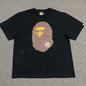 Black BAPE Big Ape Head T-shirt front view with brown and yellow graphic