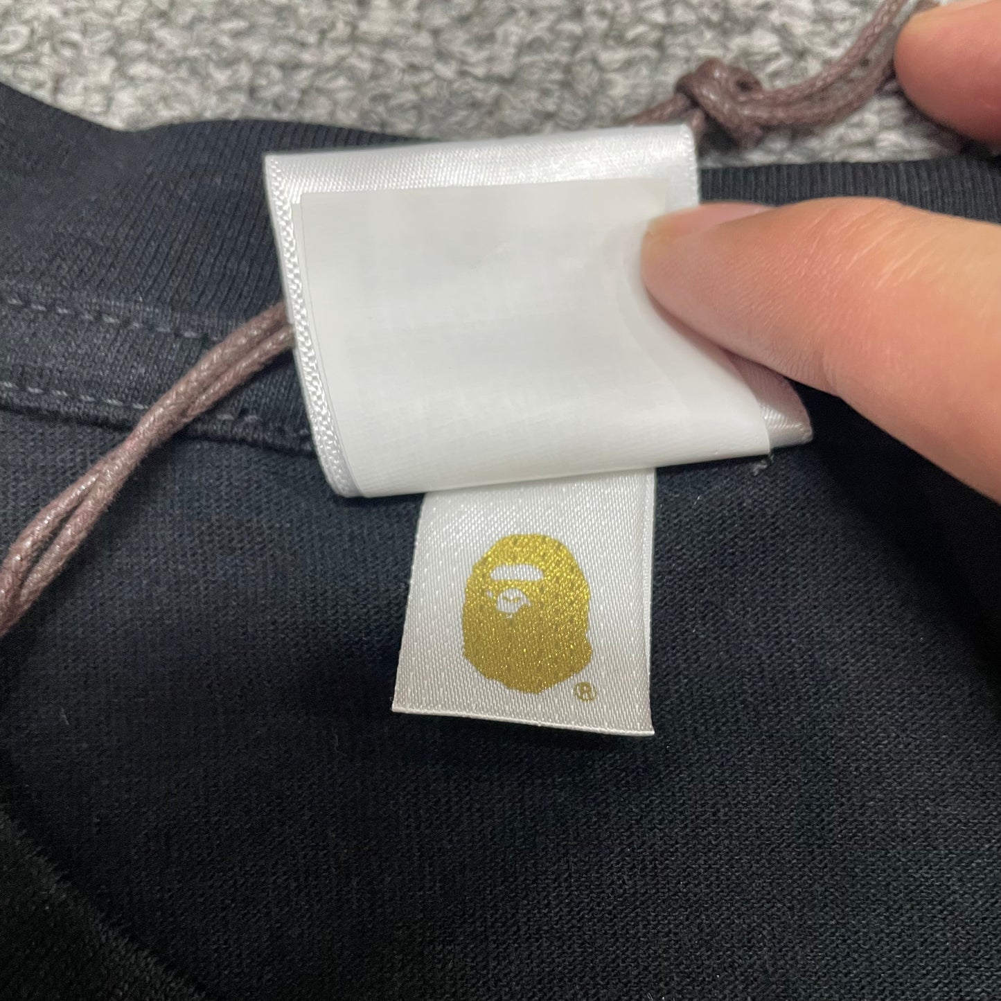 Gold label detail of black BAPE Big Ape Head T-shirt