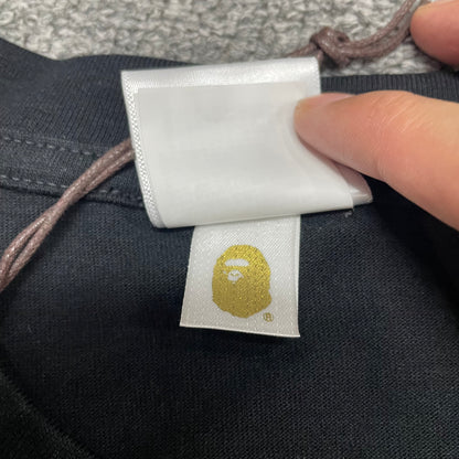 Gold label detail of black BAPE Big Ape Head T-shirt