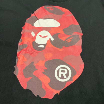 Close-up of red camo Ape Head front graphic on black BAPE T-shirt