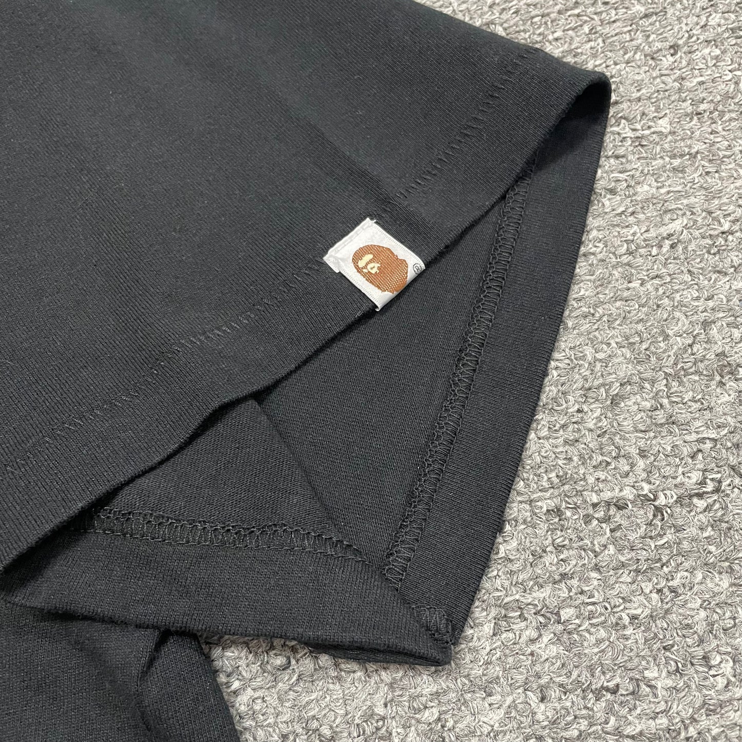 Sleeve label detail of black BAPE Color Camo Big Ape Head T-shirt