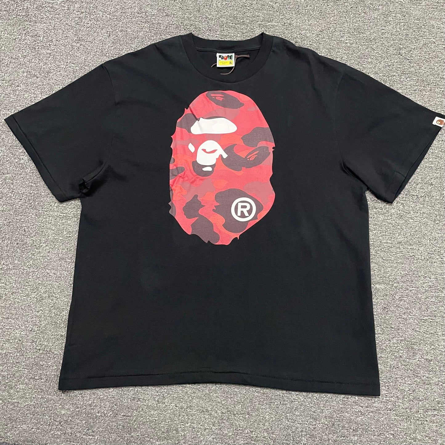 Black BAPE Color Camo Big Ape Head T-shirt front view with red camo graphic