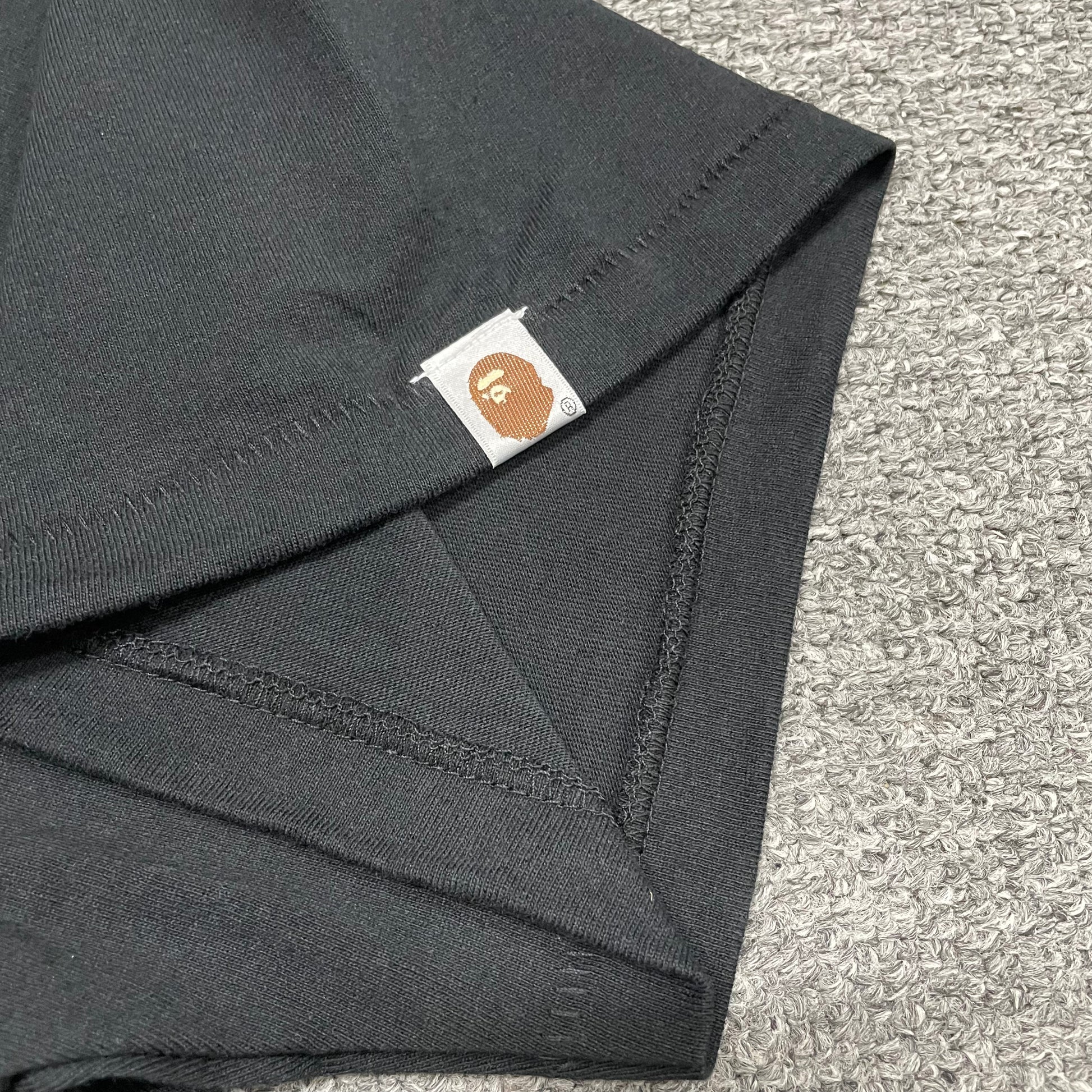 BAPE Ape Head sleeve label detail on black ABC Camo College T-shirt