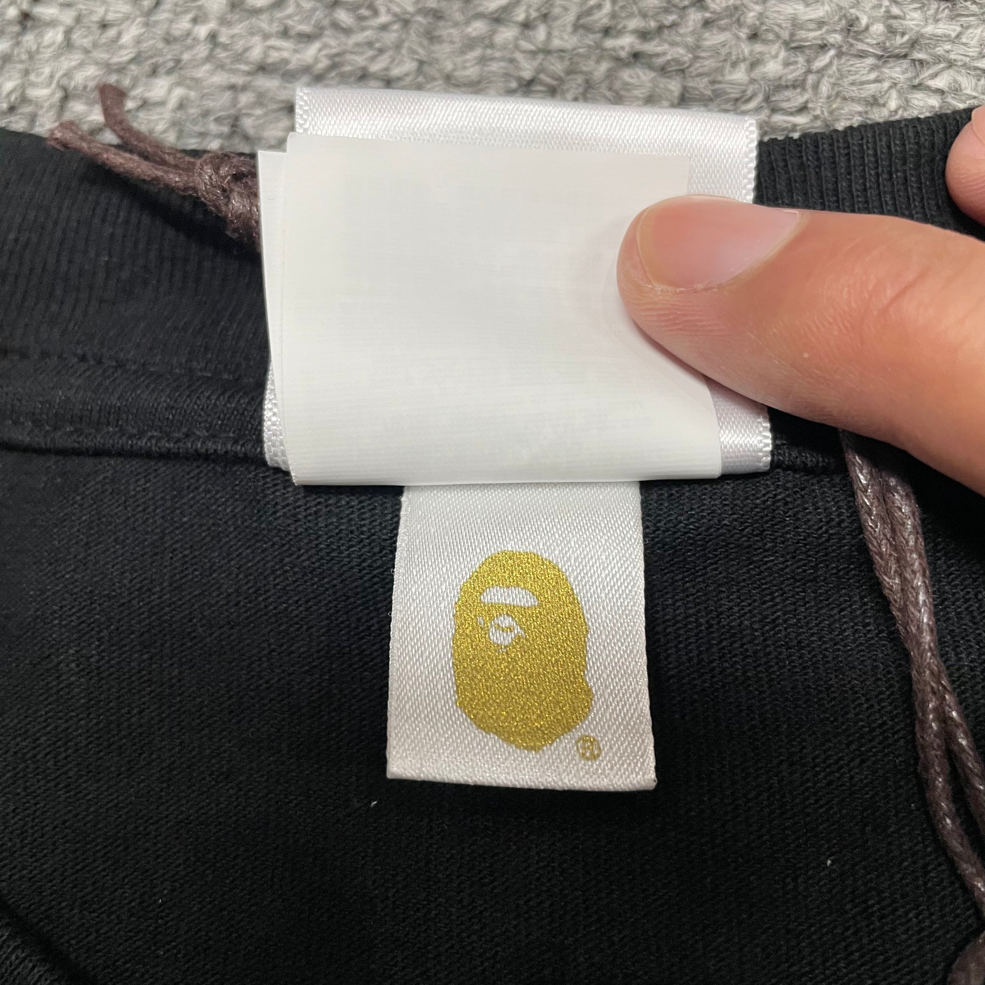 Gold label detail on black BAPE ABC Camo College T-shirt