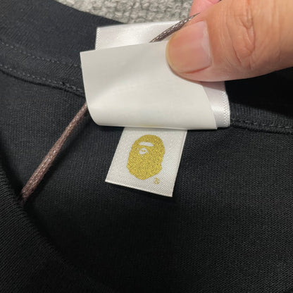 Gold label detail on black BAPE Space Camo Big Ape Head T-shirt