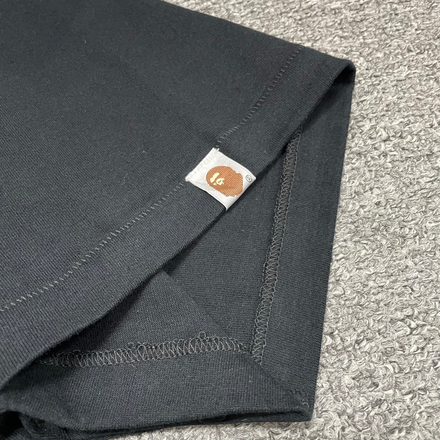 BAPE Ape Head sleeve label detail on black Space Camo T-shirt