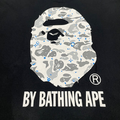 Close-up of grey white and blue Space Camo Ape Head graphic on black BAPE T-shirt