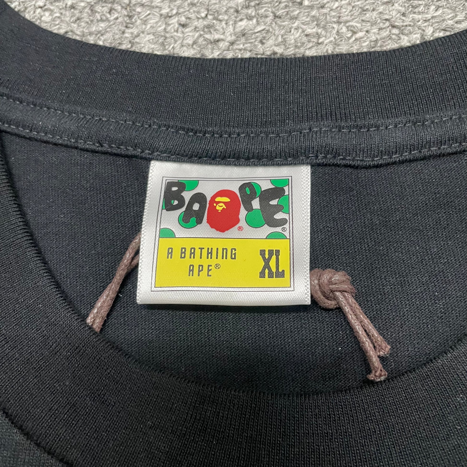 Neck label detail of black BAPE Baby Milo Ape Head T-shirt