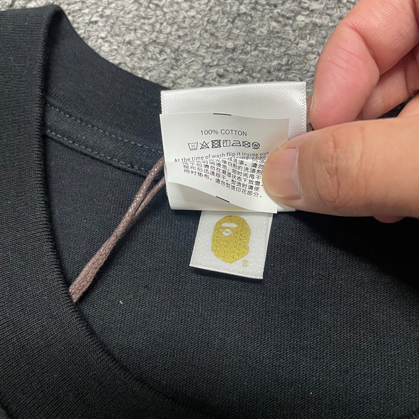 Gold label detail of black BAPE Baby Milo Ape Head T-shirt