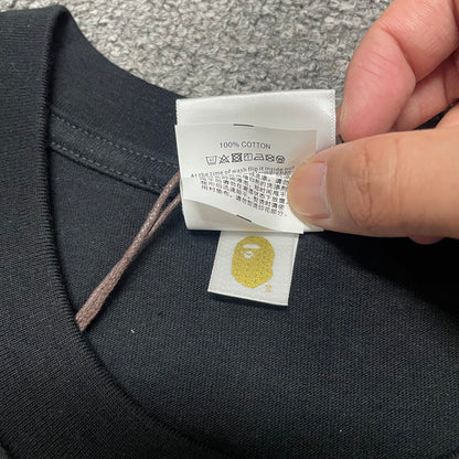 Gold label detail of black BAPE Baby Milo Ape Head T-shirt
