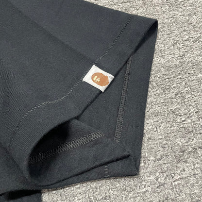 Sleeve label detail of black BAPE Baby Milo Ape Head T-shirt