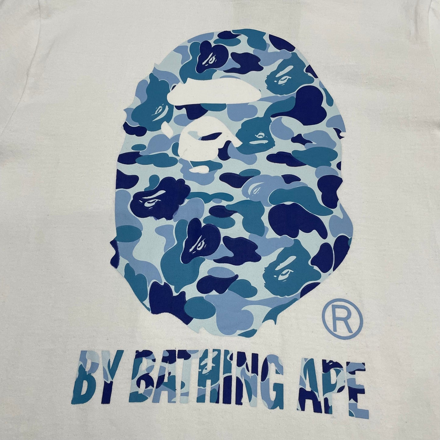 Close-up of blue camo Ape Head graphic on white BAPE T-shirt