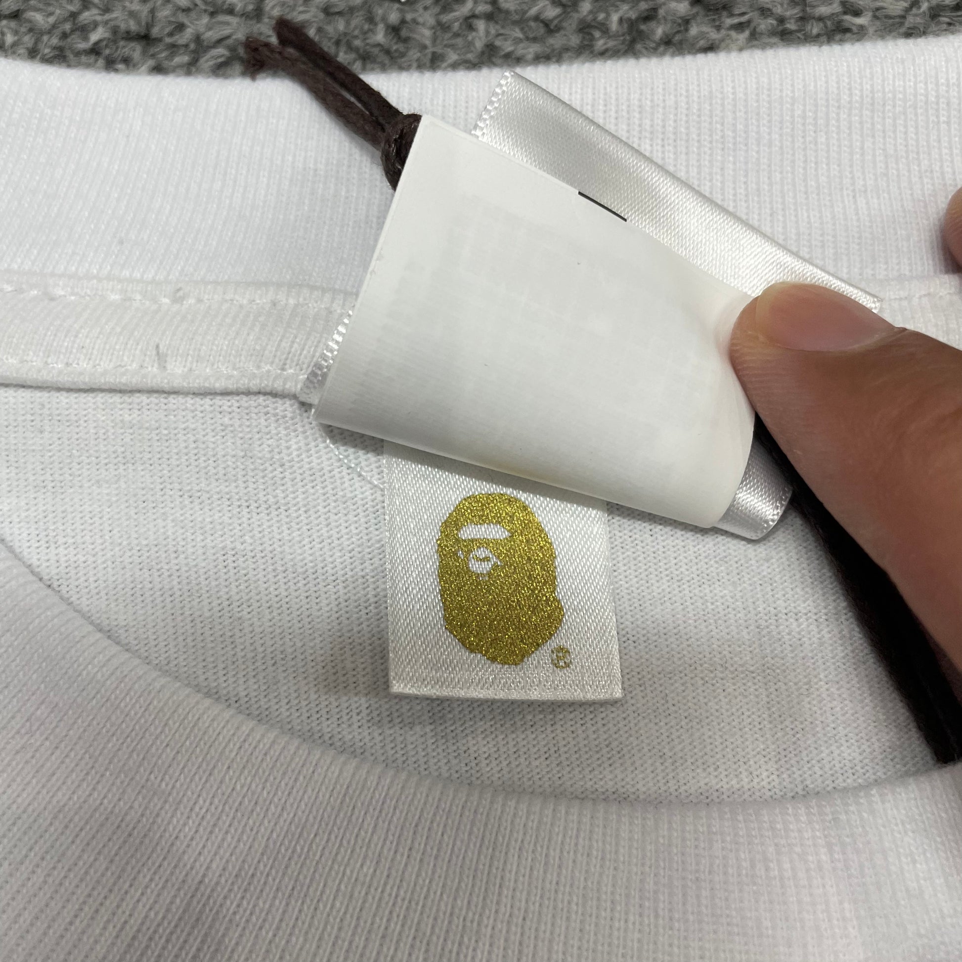 Gold label detail on white BAPE blue camo Big Ape Head T-shirt