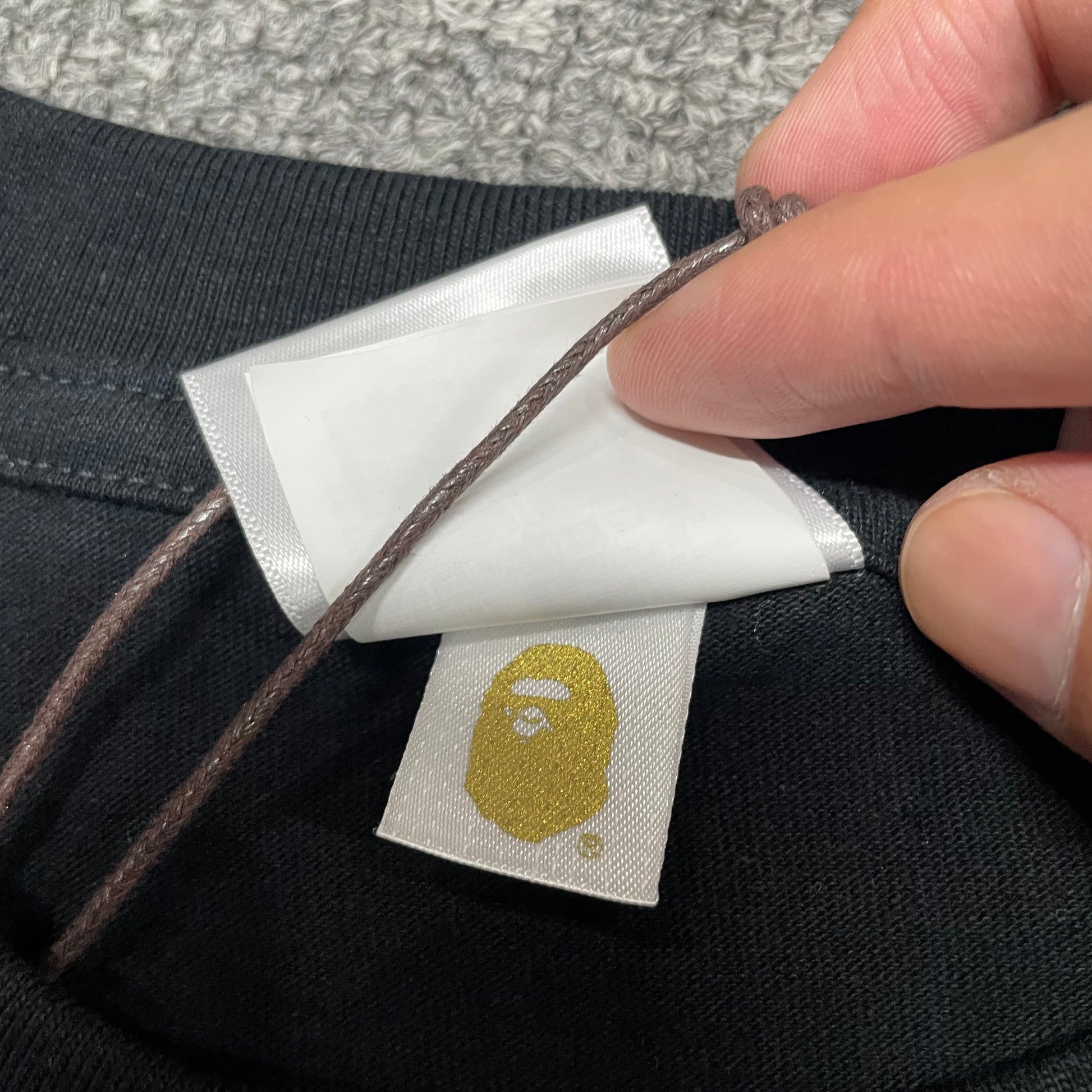 Gold label detail on black BAPE ABC Camo College T-shirt