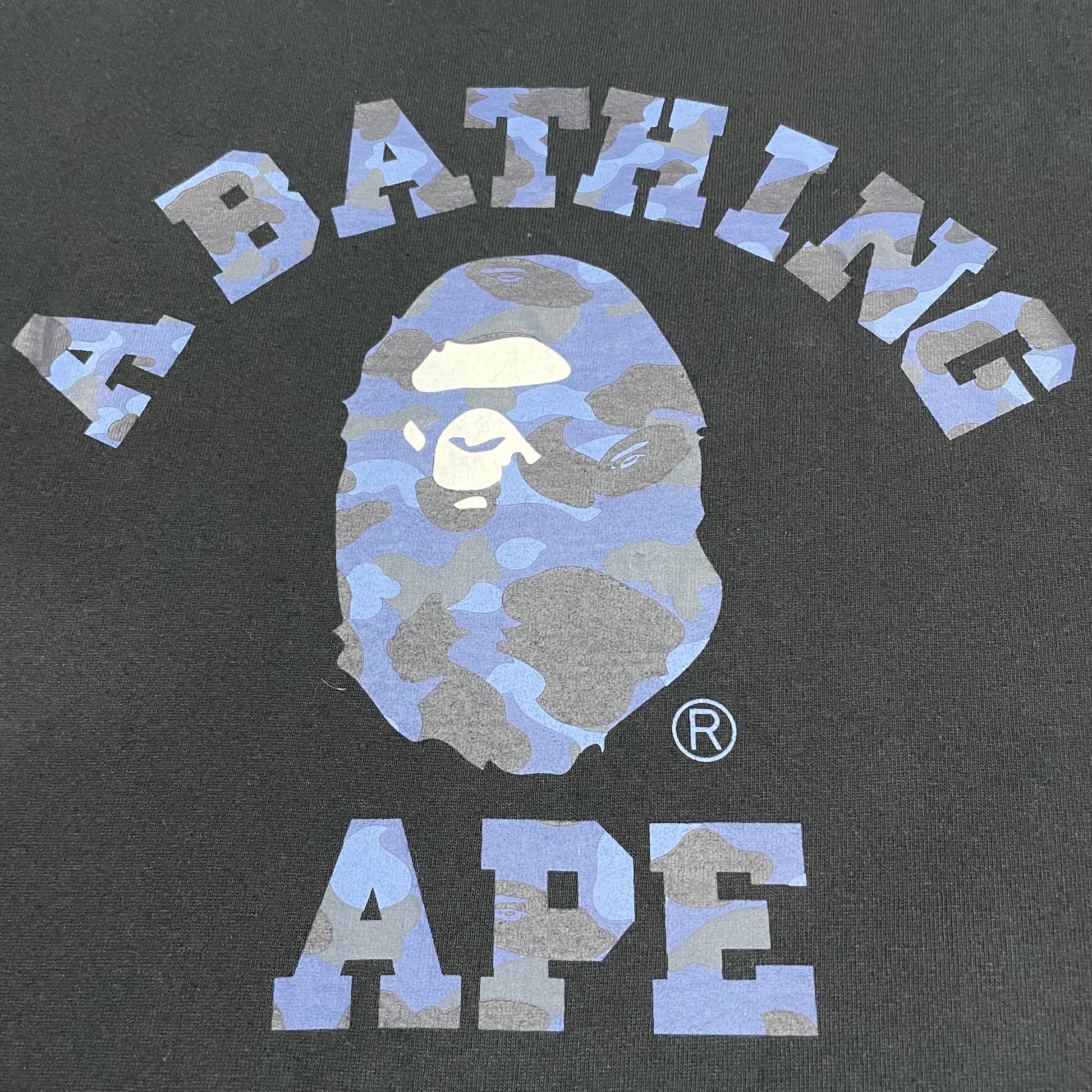 Detailed view of blue camo Ape Head graphic on black BAPE T-shirt