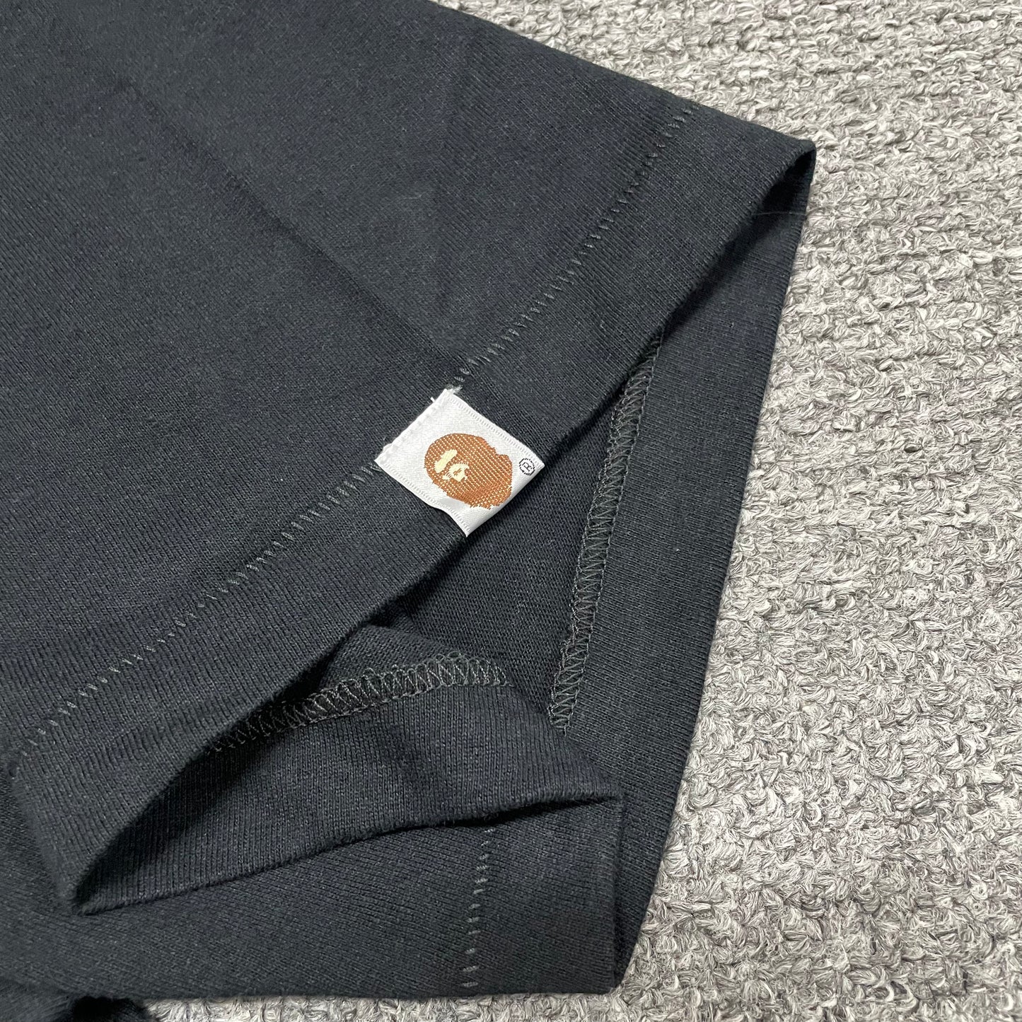 BAPE Ape Head sleeve label detail on black ABC Camo College T-shirt