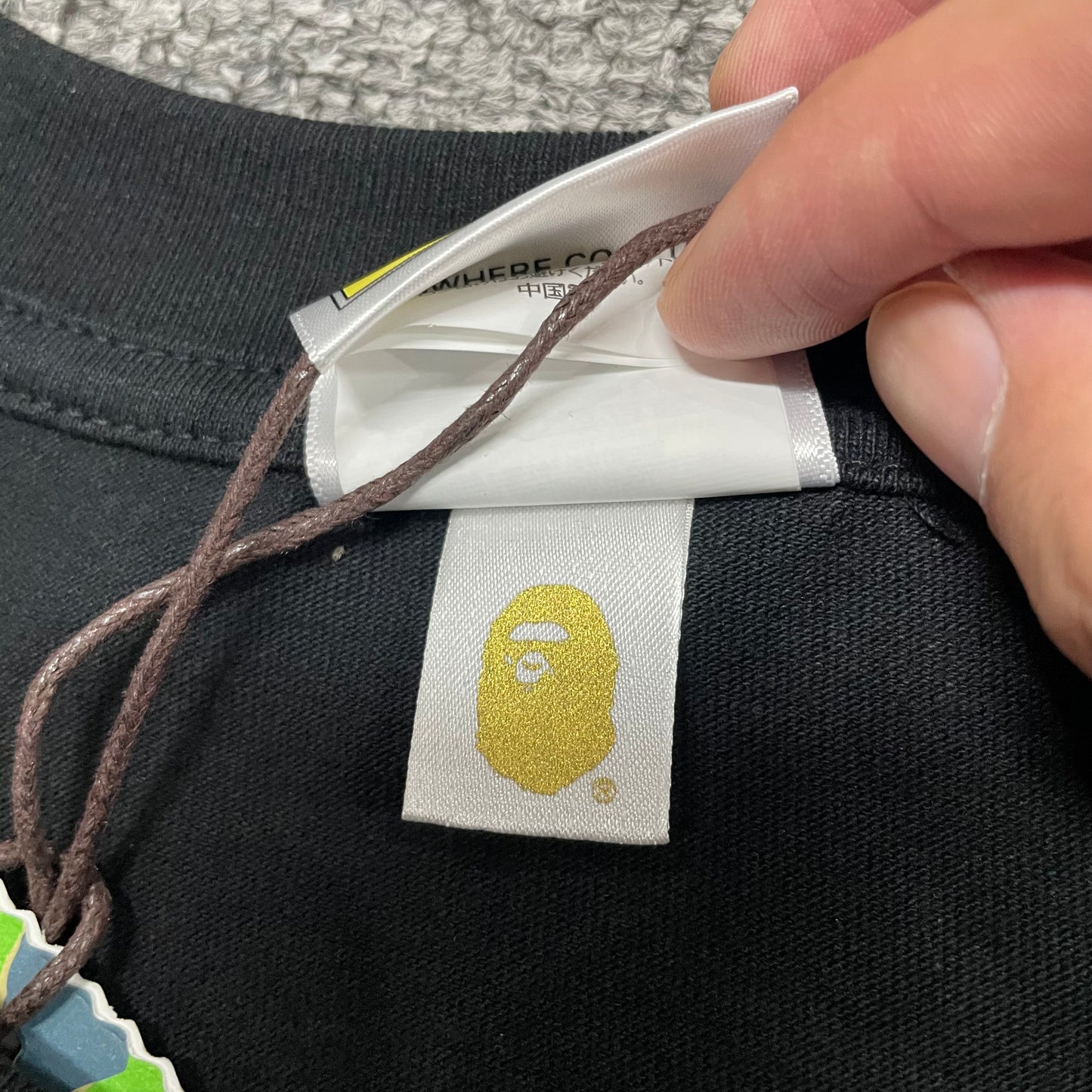 Gold label detail on black BAPE ABC Camo College T-shirt