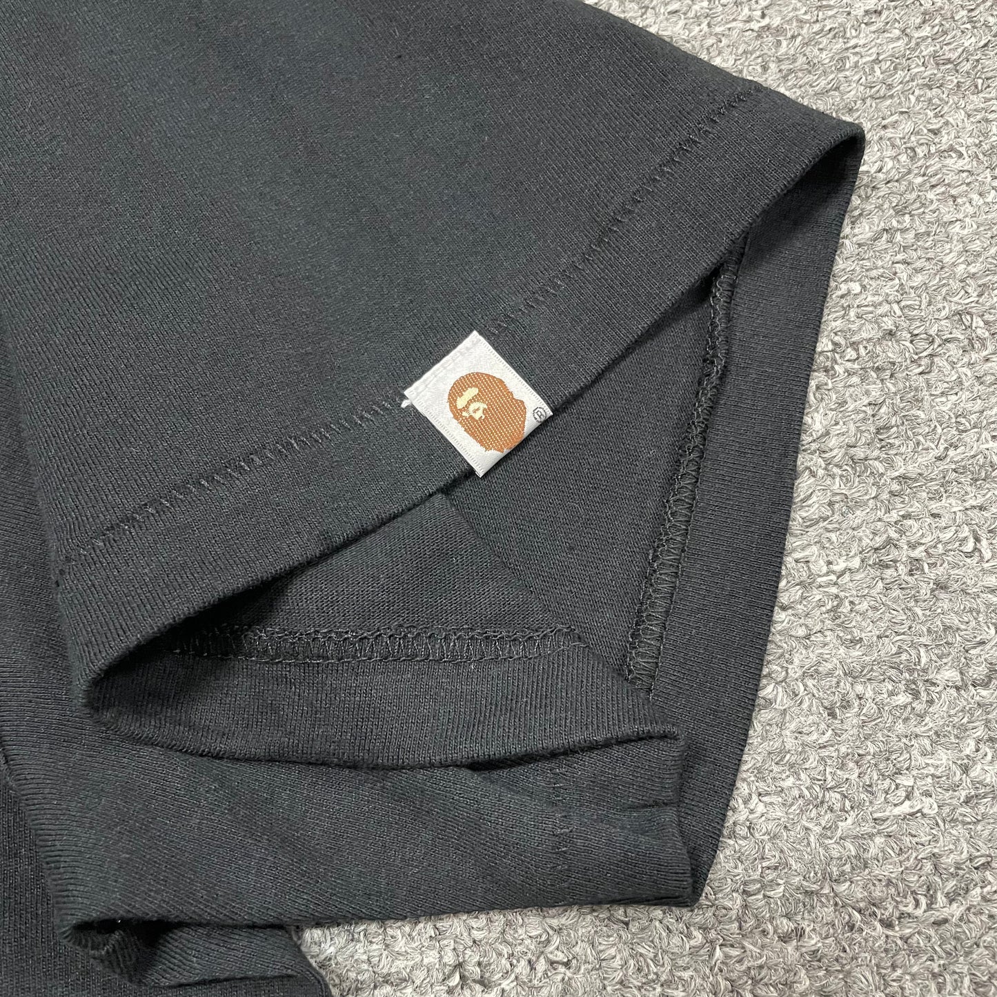 BAPE Ape Head sleeve label detail on black ABC Camo College T-shirt