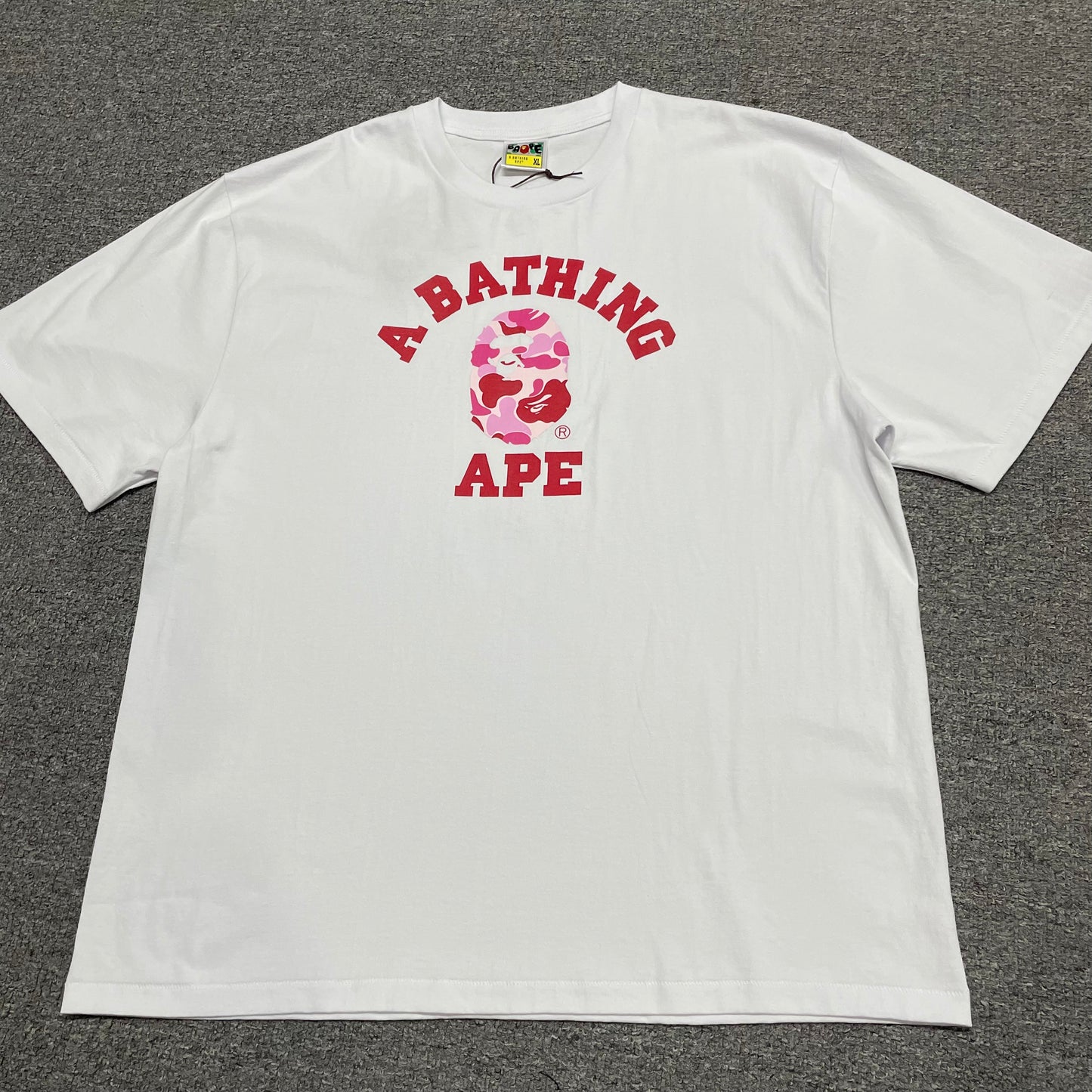 White BAPE ABC Camo College T-shirt front view with pink camo Ape Head graphic