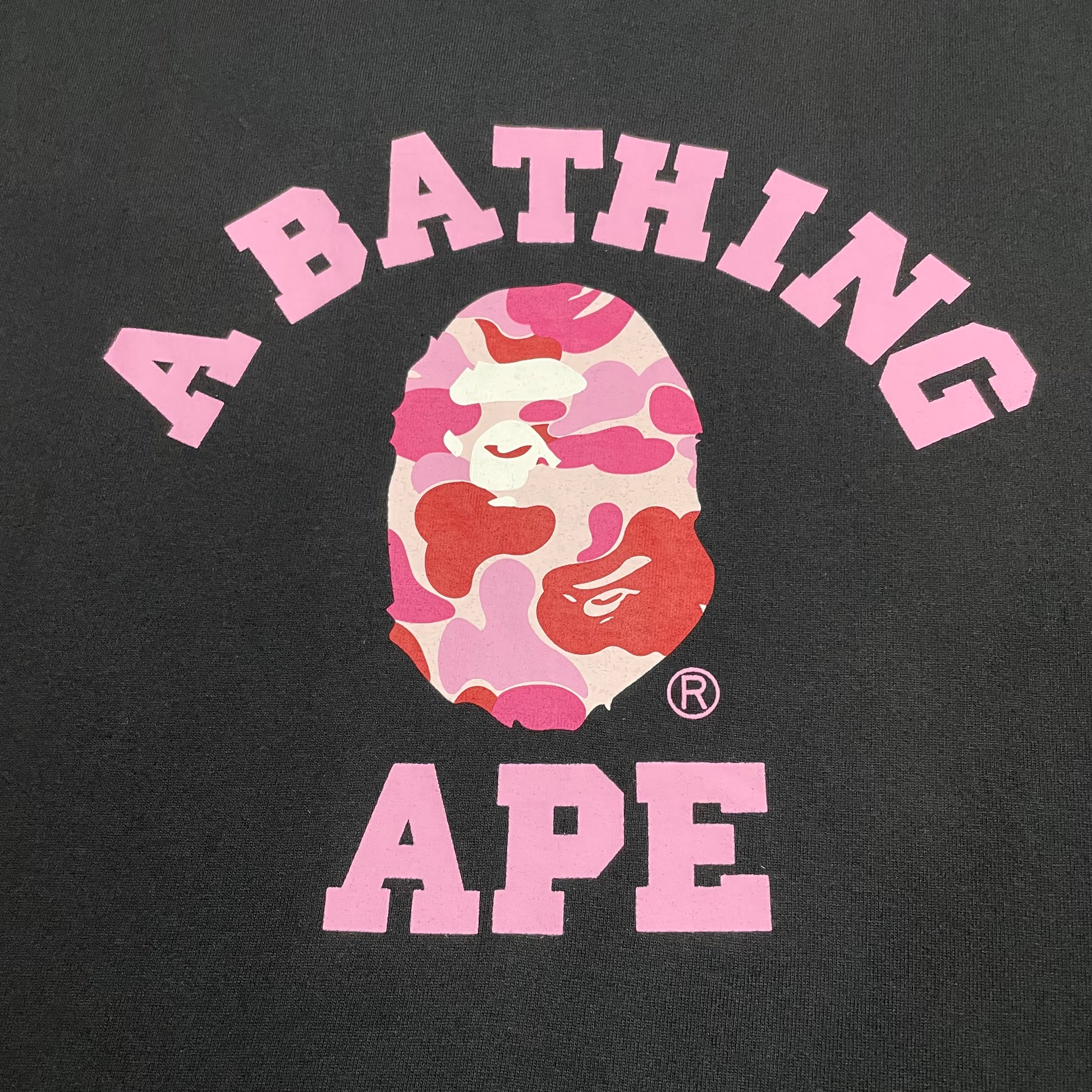 Close-up of pink ABC Camo graphic on black BAPE College T-shirt
