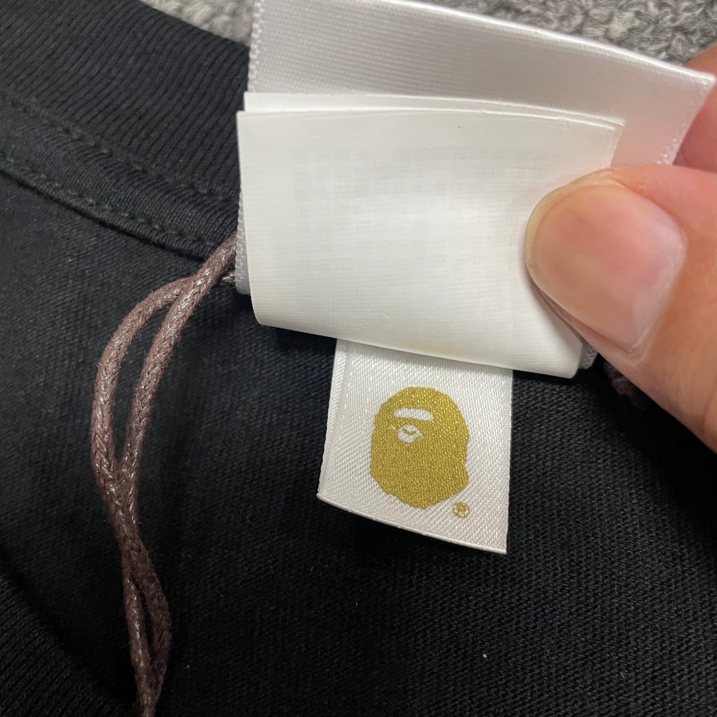 Gold label detail on black BAPE US Ape Head STA T-shirt